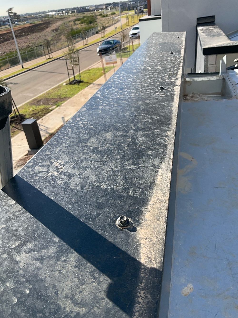 Cappings fixed from above, which lets water track into the joint, found during a practical completion inspection in Tarneit